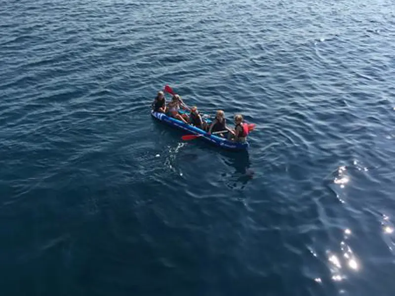 Five guests using the inflatable canoe